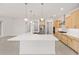 Bright open kitchen features stainless steel appliances, large island, and pendant lights at 9945 Sw 83Rd Ln, Ocala, FL 34481