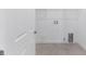 Bright laundry room features hookups, overhead rack, and easy access to appliances at 9945 Sw 83Rd Ln, Ocala, FL 34481