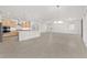 Open floorplan with easy access to kitchen with stainless appliances and central island at 9945 Sw 83Rd Ln, Ocala, FL 34481