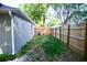 The backyard has green space and a wooden fence, offering privacy and room for outdoor activities at 10 Banyan Track Way, Ocala, FL 34472
