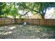 Fenced backyard featuring green space and mature trees provides a private outdoor retreat at 10 Banyan Track Way, Ocala, FL 34472