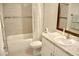 Well-lit bathroom featuring a tiled shower-tub combo, a modern vanity, and a stylish mirror at 10 Banyan Track Way, Ocala, FL 34472