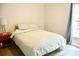 Cozy bedroom with a comfortable bed, wooden floors, and a bright window for natural light at 10 Banyan Track Way, Ocala, FL 34472