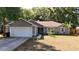 Charming single-story home featuring a well-maintained lawn, attached garage, and neutral color palette at 10 Banyan Track Way, Ocala, FL 34472