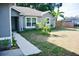 Charming single-story home featuring a well-maintained lawn, lush landscaping, and a welcoming pathway at 10 Banyan Track Way, Ocala, FL 34472