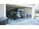 Garage featuring an SUV, tools, and storage solutions, providing ample space and functionality at 10 Banyan Track Way, Ocala, FL 34472