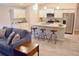 Open-concept kitchen features white cabinets, granite countertops, and stainless steel appliances at 10 Banyan Track Way, Ocala, FL 34472
