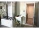 Utility room features a utility sink, HVAC system, and door to the laundry area at 10 Banyan Track Way, Ocala, FL 34472