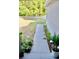 Walkway from covered entry area with potted plants leading to the sidewalk at 10 Banyan Track Way, Ocala, FL 34472