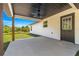 Back porch with a ceiling fan and a view of the large backyard at 10605 Se 146Th Ln, Summerfield, FL 34491