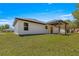 A well manicured backyard featuring a covered patio area at 10605 Se 146Th Ln, Summerfield, FL 34491