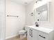 Updated bathroom featuring modern vanity with black fixtures and a glass door shower stall with white marble tile at 10605 Se 146Th Ln, Summerfield, FL 34491