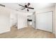 Bright bedroom boasts modern ceiling fan, and closet, complemented by wood-look flooring at 10605 Se 146Th Ln, Summerfield, FL 34491