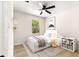 Cozy bedroom with a ceiling fan and a view of the outdoors at 10605 Se 146Th Ln, Summerfield, FL 34491