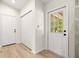 Entryway features a door with window panels and closet space, filled with natural light at 10605 Se 146Th Ln, Summerfield, FL 34491
