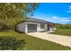 Single-story home with an attached garage, showcasing a well-maintained lawn and inviting curb appeal at 10605 Se 146Th Ln, Summerfield, FL 34491