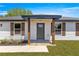 Welcoming front entrance with modern door, house number display and charming decorative shutters at 10605 Se 146Th Ln, Summerfield, FL 34491
