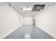 Well-lit and spacious garage with clean, painted floors, offering plenty of room for storage at 10605 Se 146Th Ln, Summerfield, FL 34491