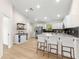 Spacious kitchen with white cabinets, stainless steel appliances, and a breakfast bar at 10605 Se 146Th Ln, Summerfield, FL 34491