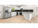 Bright kitchen featuring white cabinets, stainless steel appliances, and a breakfast bar at 10605 Se 146Th Ln, Summerfield, FL 34491