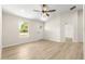 Bright living room with wood-look floors, a ceiling fan and a neutral color palette at 10605 Se 146Th Ln, Summerfield, FL 34491
