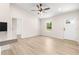 Open-concept living area features light-toned flooring, a ceiling fan, and bright natural light at 10605 Se 146Th Ln, Summerfield, FL 34491