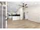 Open concept living space features a kitchen with stainless appliances and wood-look floors at 10605 Se 146Th Ln, Summerfield, FL 34491
