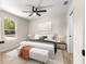 Comfortable main bedroom featuring warm, neutral colors and a view of the outdoors at 10605 Se 146Th Ln, Summerfield, FL 34491