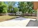 Fenced backyard with a shed, concrete patio, and mature trees at 1145 Se 32Nd Ave, Ocala, FL 34471