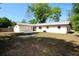 Home's backyard with patio, featuring a lawn and mature trees at 1145 Se 32Nd Ave, Ocala, FL 34471