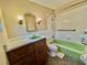 Retro bathroom showcasing green fixtures, unique vanity, and tiled walls at 1145 Se 32Nd Ave, Ocala, FL 34471