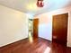 Bedroom with hardwood flooring, light walls, and a view into the en-suite bathroom at 1145 Se 32Nd Ave, Ocala, FL 34471