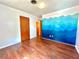 Bedroom with hardwood floors and a vibrant mural on one wall at 1145 Se 32Nd Ave, Ocala, FL 34471