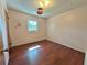 Cozy bedroom with warm hardwood floors, light pink walls, and a bright window at 1145 Se 32Nd Ave, Ocala, FL 34471