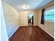 Dining area featuring wood floors and a view of the kitchen through the doorway at 1145 Se 32Nd Ave, Ocala, FL 34471