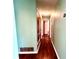 Hallway showcasing fresh green paint and wood-look flooring leading to bedrooms at 1145 Se 32Nd Ave, Ocala, FL 34471