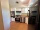 Kitchen boasting stainless steel appliances, white cabinets, and wood-look flooring at 1145 Se 32Nd Ave, Ocala, FL 34471