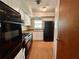 Kitchen with stainless steel oven and refrigerator, window, and classic white cabinetry at 1145 Se 32Nd Ave, Ocala, FL 34471