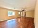 View of the large living room with dark wood-look floors and natural light at 1145 Se 32Nd Ave, Ocala, FL 34471