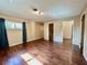 Open living room featuring wood floors, neutral walls and ample natural light at 1145 Se 32Nd Ave, Ocala, FL 34471