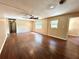 Spacious living room with dark wood floors, ceiling fan, and abundant natural light at 1145 Se 32Nd Ave, Ocala, FL 34471