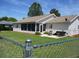 Spacious backyard featuring a screened-in porch, patio area with furniture, and chain-link fence at 11536 Sw 138Th Ln, Dunnellon, FL 34432