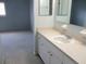 Well-lit bathroom featuring a vanity with a sink and a mirror, next to a bedroom at 11536 Sw 138Th Ln, Dunnellon, FL 34432