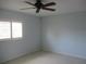 Comfortable bedroom with ceiling fan, neutral colored walls, and bright natural light at 11536 Sw 138Th Ln, Dunnellon, FL 34432