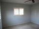 Bright carpeted bedroom with a ceiling fan and a window with blinds at 11536 Sw 138Th Ln, Dunnellon, FL 34432