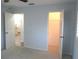 Bedroom with an open closet and an open door looking to a kitchen at 11536 Sw 138Th Ln, Dunnellon, FL 34432