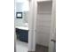 View of a closet and a bathroom with a shower and vanity at 11536 Sw 138Th Ln, Dunnellon, FL 34432