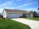 Charming single-Gathering home with attached garage, well-kept lawn and concrete driveway at 11536 Sw 138Th Ln, Dunnellon, FL 34432