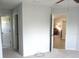 Neutral hallway leading to bedroom with natural light and an adjacent open living area at 11536 Sw 138Th Ln, Dunnellon, FL 34432