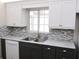 Kitchen featuring a stainless steel appliance, and gray countertops, complemented by sleek, modern cabinetry at 11536 Sw 138Th Ln, Dunnellon, FL 34432